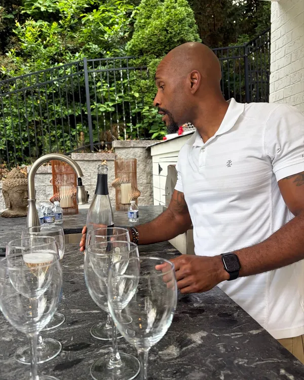 Manuel Patterson arranging glasses and bottles at an outdoor bar before a tasting